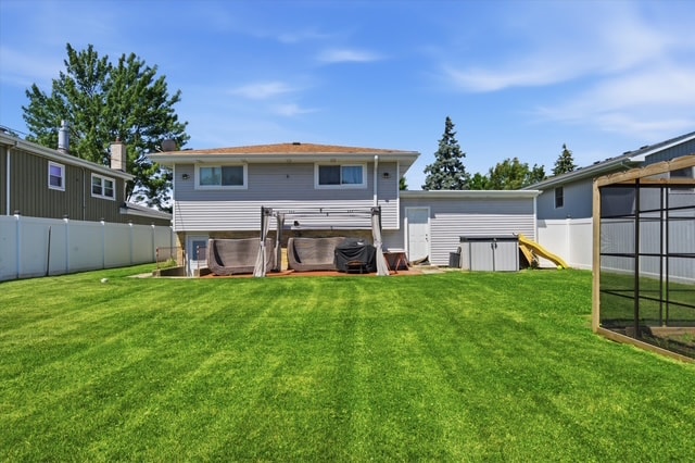 Wide enclosed backyard with lush green lawn