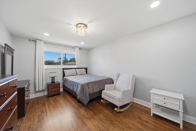 Primary bedroom with rocking chair and dresser